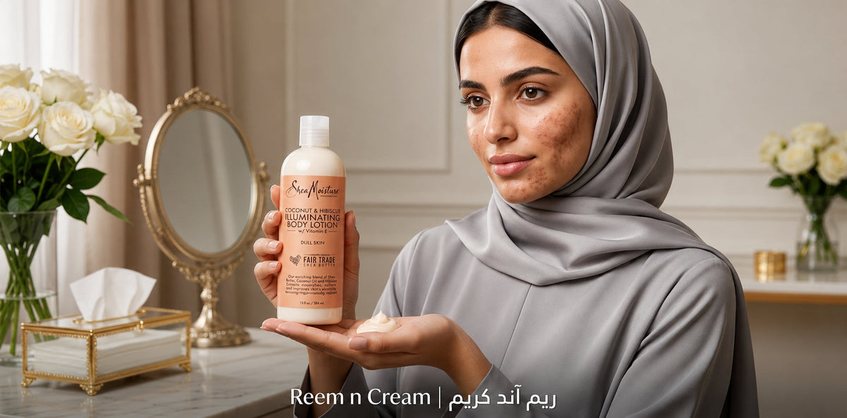 Woman in gray hijab holding SheaMoisture body lotion with cream in hand, showcasing skincare against an elegant vanity backdrop.