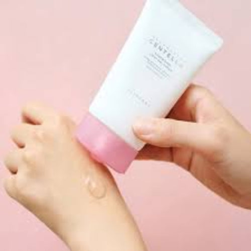 Person applying SKIN1004 Centella Poremizing Light Gel Cream onto hand, showing creamy white product texture up close.